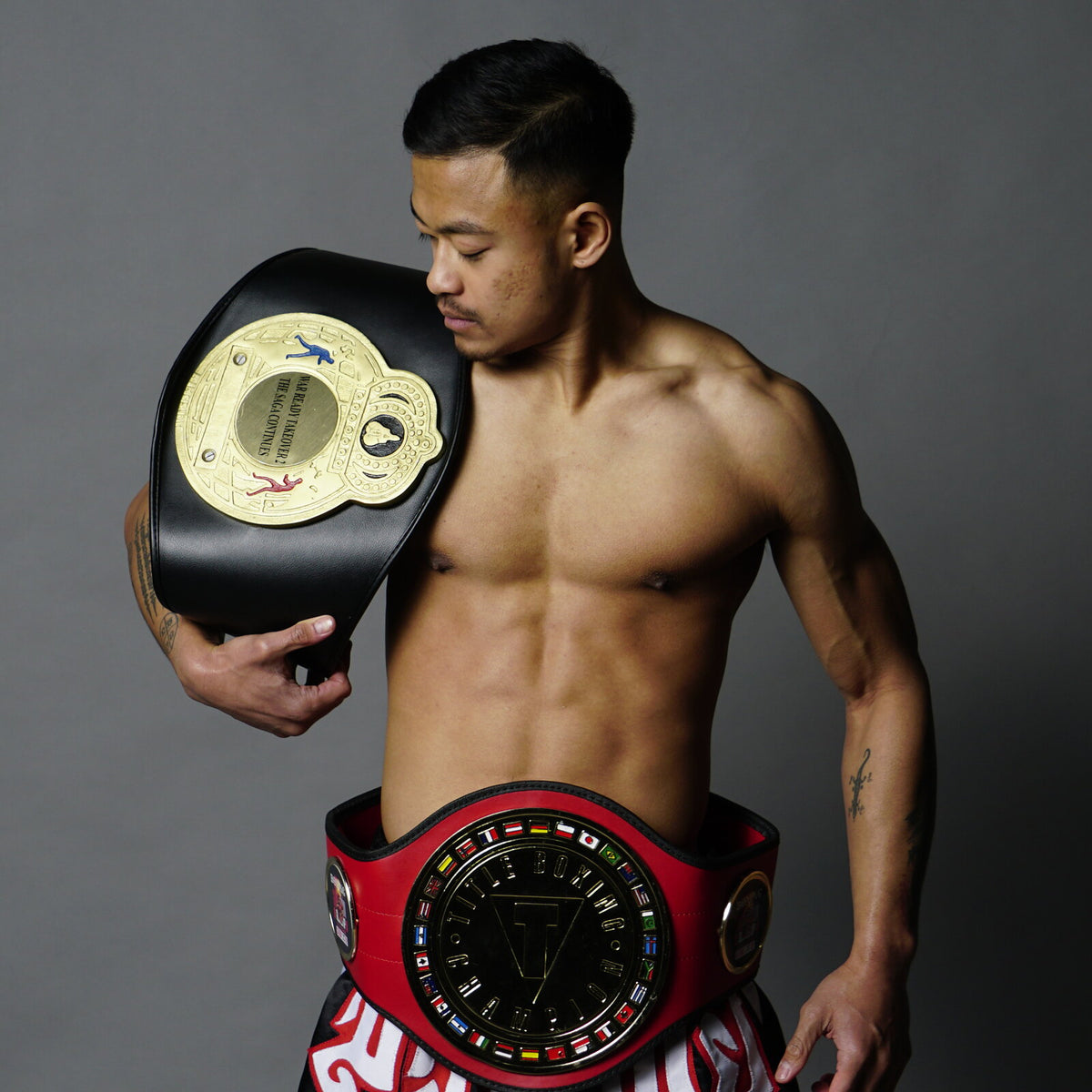 Rada Rann with two belts awarded for amateur boxing fights he won.
