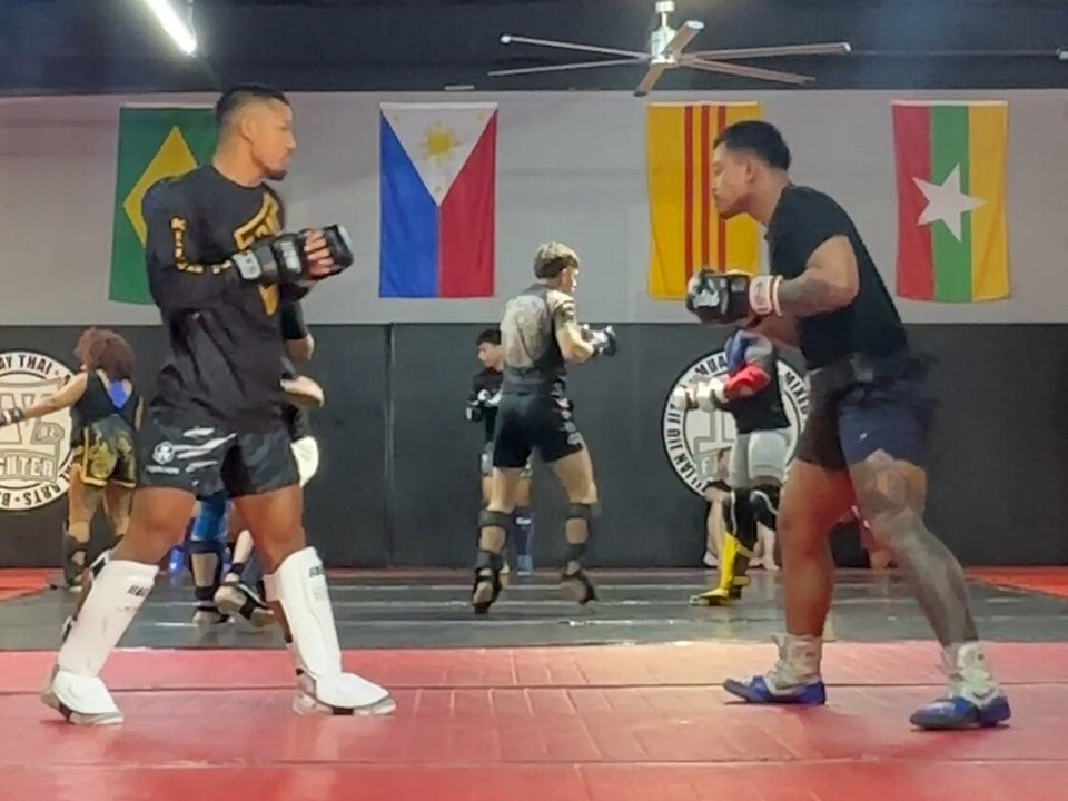 Rada Rann (right) sparring with UFC champion Joshua Van (left) in a Houston gym.